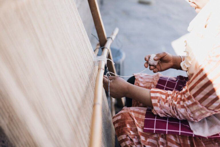Person weaving on traditional loom